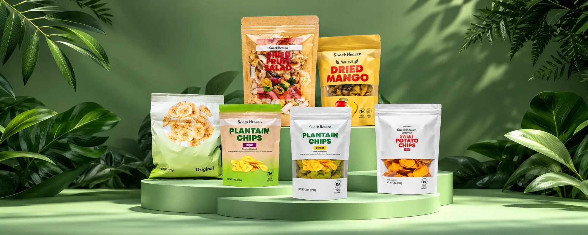 All six Snack Heaven products standing on green plinths among tropical leaves